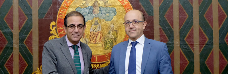 Miguel Ángel Castro (Universidad de Sevilla) y Raúl Ripio (Director del área de Administraciones Públicas de Indra) firman el acuerdo de colaboración